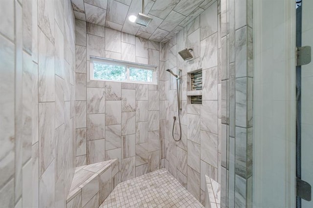 full bath featuring a tile shower