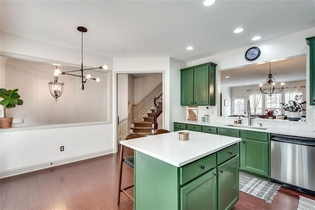 kitchen with a sink, dishwasher, a notable chandelier, and green cabinets