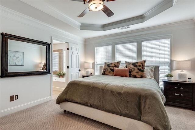 bedroom featuring ornamental molding, a tray ceiling, multiple windows, and visible vents