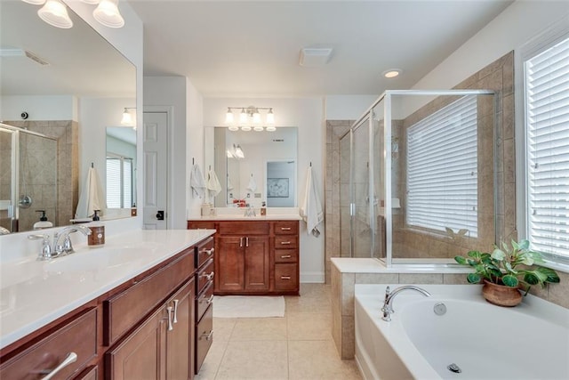 full bathroom featuring a garden tub, two vanities, a stall shower, a sink, and tile patterned floors