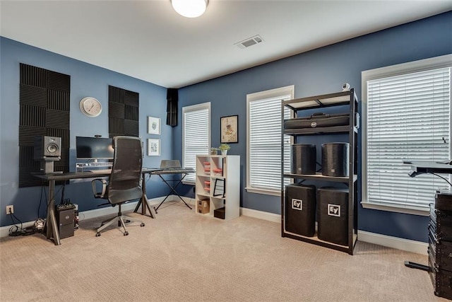 carpeted office space with visible vents and baseboards