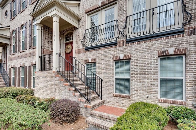 entrance to property featuring brick siding