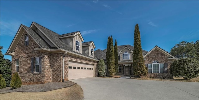 view of front of house with a garage, concrete driveway, and brick siding