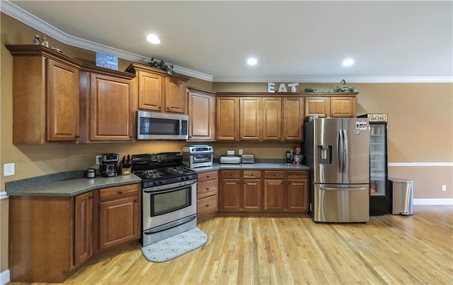 kitchen with light wood-style flooring, appliances with stainless steel finishes, brown cabinetry, and crown molding