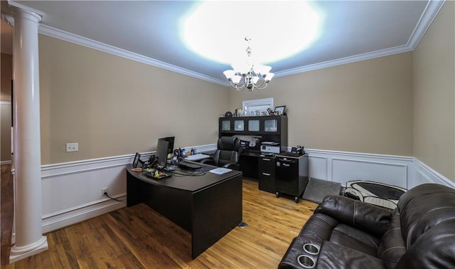 home office featuring light wood-style flooring, decorative columns, and an inviting chandelier