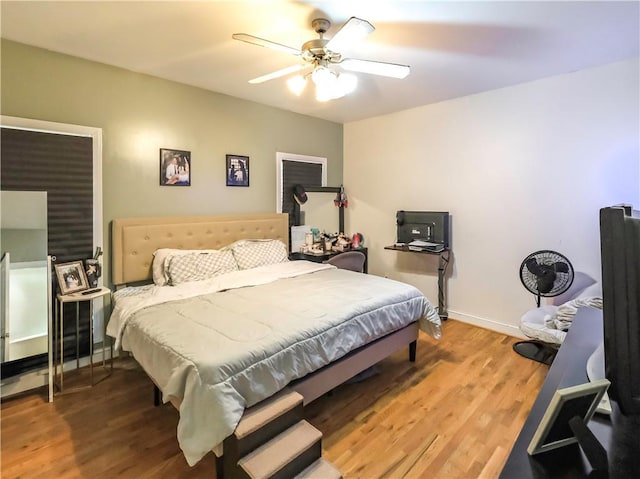 bedroom featuring ceiling fan, wood finished floors, and baseboards