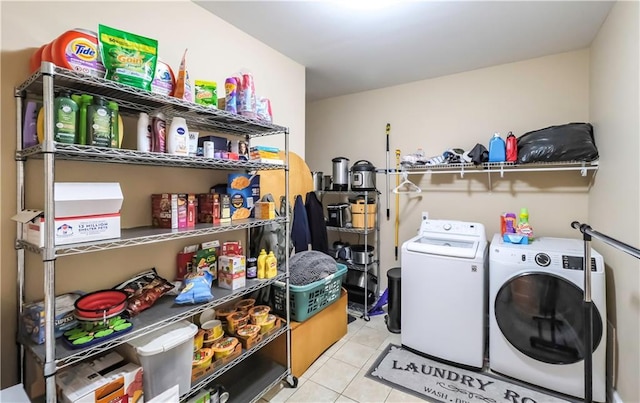 washroom featuring laundry area, separate washer and dryer, and tile patterned floors