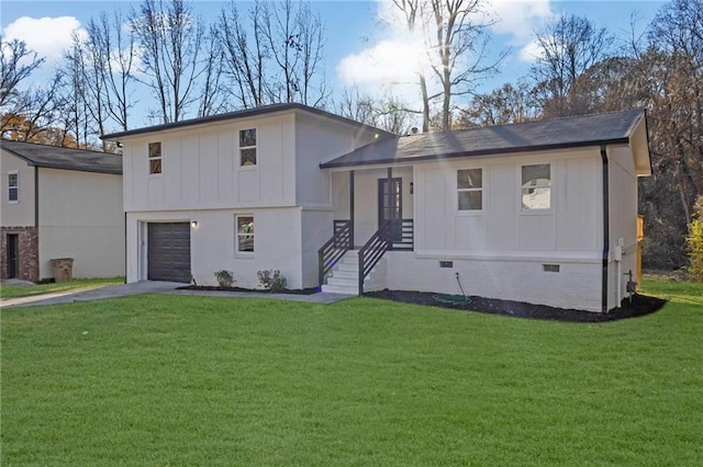 view of front facade with a garage and a front lawn