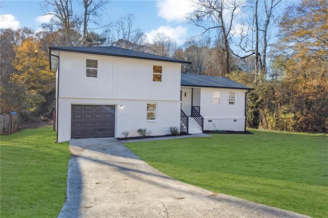 view of front of property with a front yard and a garage