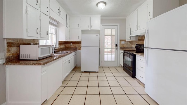 kitchen with white cabinets, white appliances, sink, and a wealth of natural light