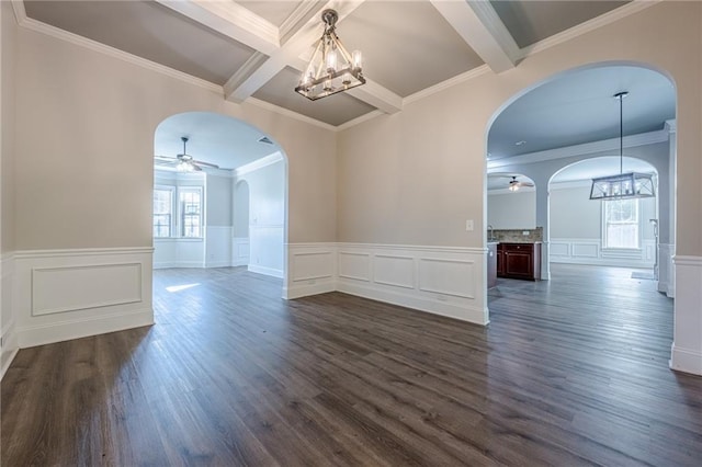 spare room featuring dark hardwood / wood-style flooring, ceiling fan with notable chandelier, coffered ceiling, and beamed ceiling