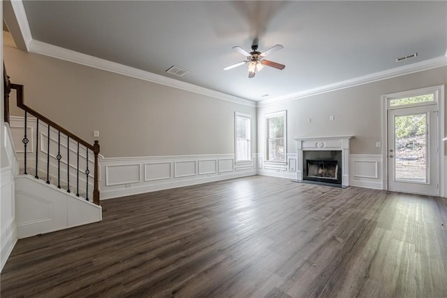 unfurnished living room featuring ceiling fan, plenty of natural light, dark wood-type flooring, and a high end fireplace