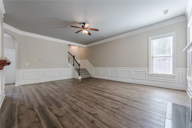 unfurnished living room featuring ceiling fan, ornamental molding, and dark hardwood / wood-style flooring