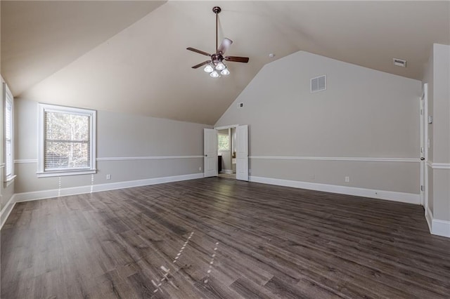 unfurnished living room with dark wood-type flooring, high vaulted ceiling, and ceiling fan