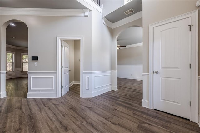 hall with dark wood-type flooring and ornamental molding