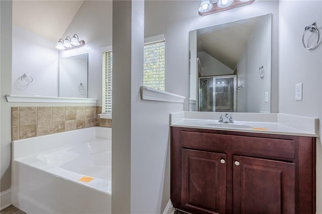 bathroom featuring vanity, vaulted ceiling, and plus walk in shower