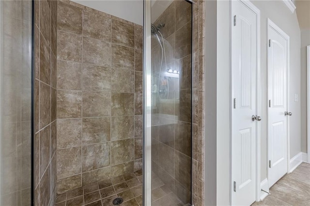 bathroom with a shower with door