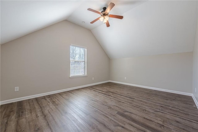 additional living space featuring lofted ceiling, dark hardwood / wood-style floors, and ceiling fan