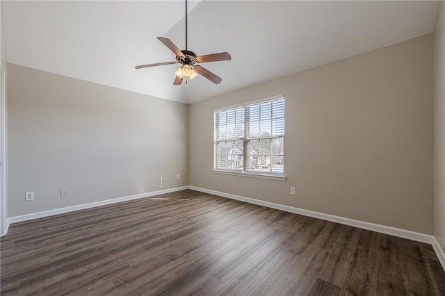 spare room featuring vaulted ceiling, dark wood-type flooring, and ceiling fan