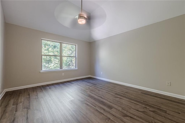 spare room featuring vaulted ceiling, dark hardwood / wood-style floors, and ceiling fan