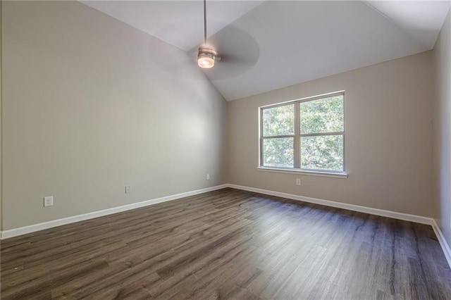 unfurnished room with vaulted ceiling, dark hardwood / wood-style floors, and ceiling fan