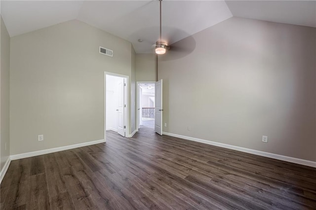 empty room featuring ceiling fan, lofted ceiling, and dark hardwood / wood-style floors