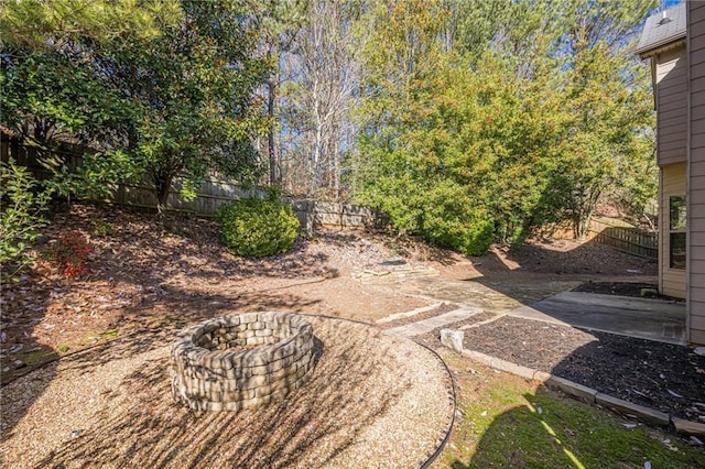 view of yard featuring a patio and an outdoor fire pit