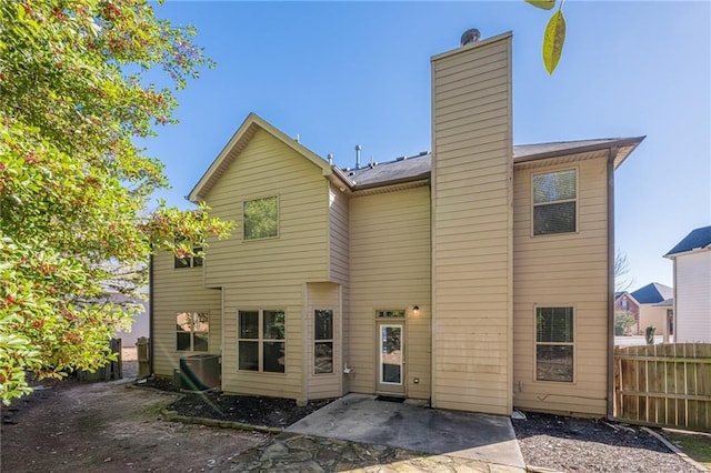 back of property featuring central AC unit and a patio