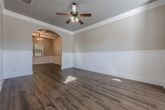 unfurnished room with crown molding, ceiling fan with notable chandelier, and dark wood-type flooring