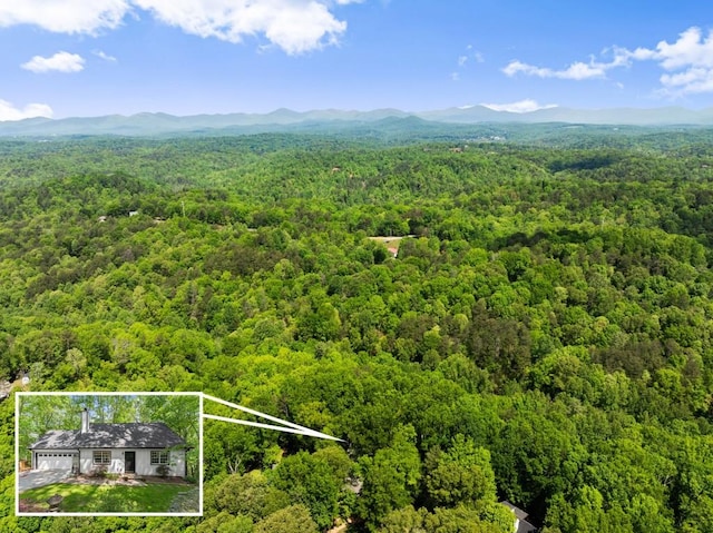 aerial view featuring a mountain view and a wooded view