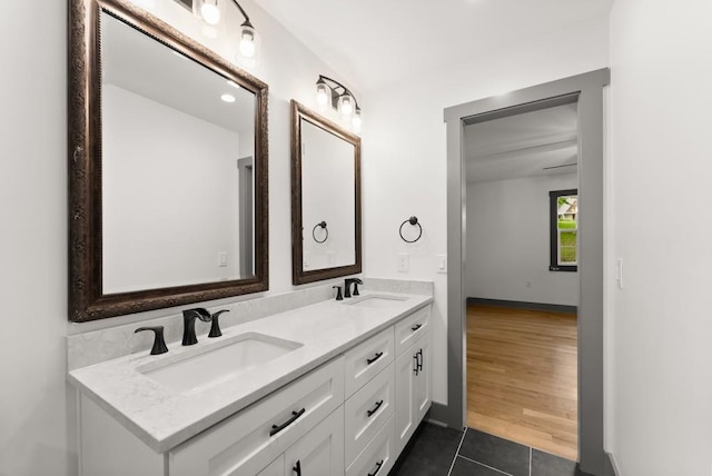 bathroom with double vanity, a sink, and tile patterned flooring