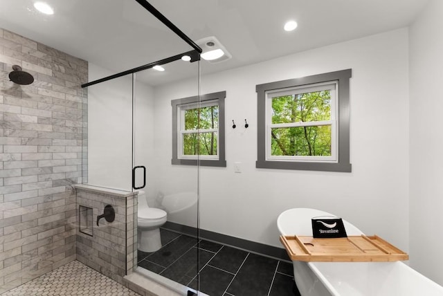 bathroom with toilet, a freestanding bath, a shower stall, and tile patterned flooring