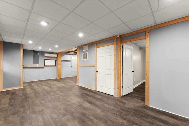 finished basement with visible vents, baseboards, and wood finished floors