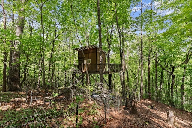 view of outdoor structure with a forest view