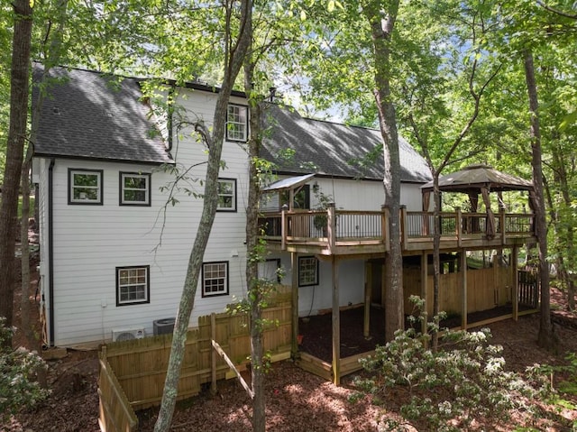 back of house featuring a gazebo, roof with shingles, fence, and a deck