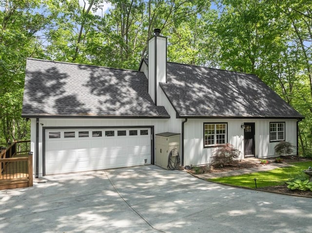 back of property with roof with shingles, fence, and a deck