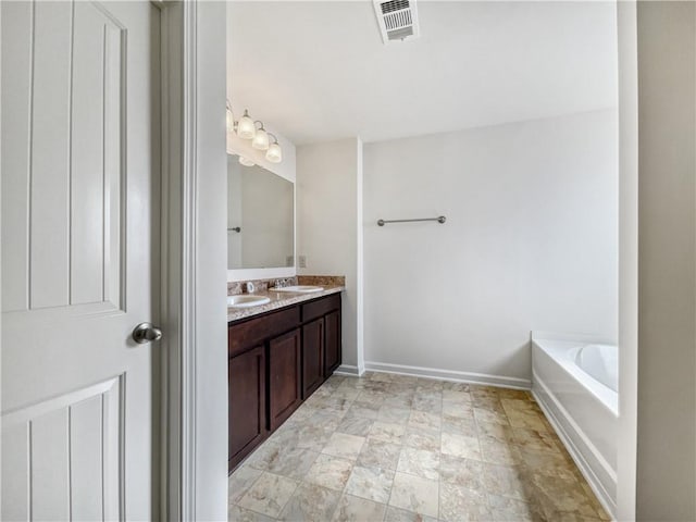 bathroom with vanity and a tub