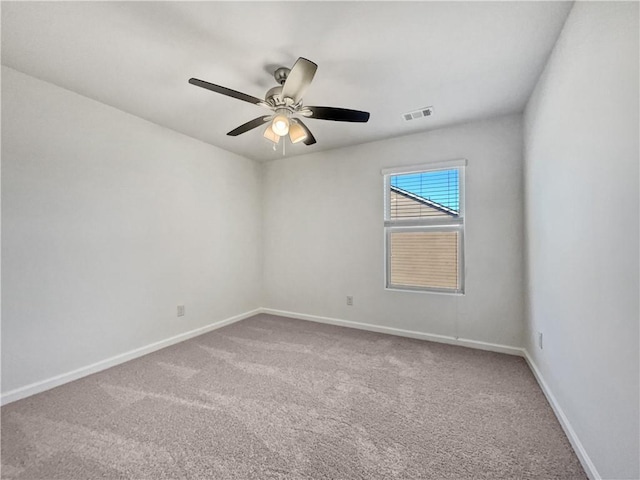 empty room with ceiling fan and carpet