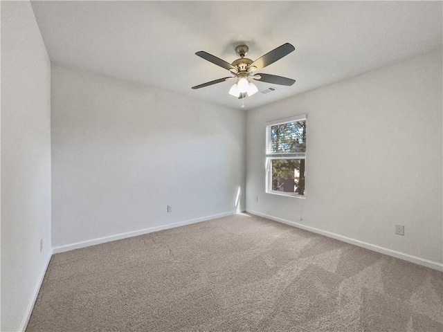 empty room with ceiling fan and carpet