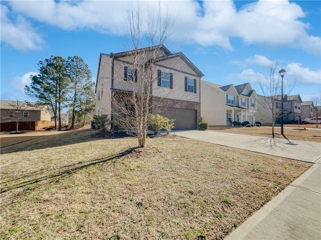 view of front of home with a front yard and a garage