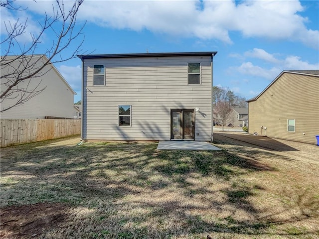 back of house featuring a patio area and a yard