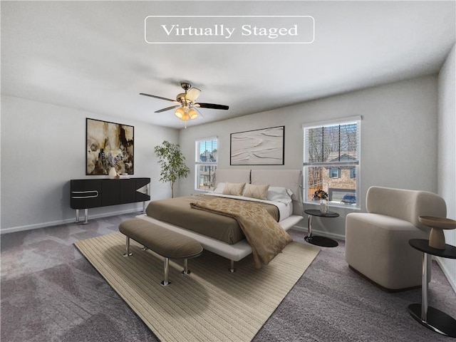 carpeted bedroom featuring multiple windows and ceiling fan