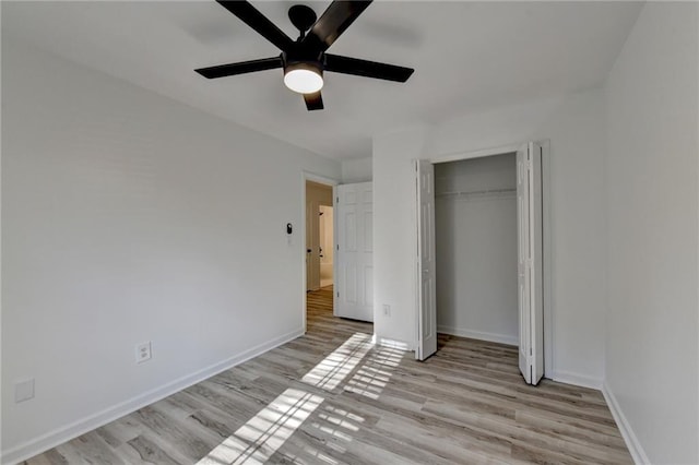 unfurnished bedroom with ceiling fan, light hardwood / wood-style floors, and a closet