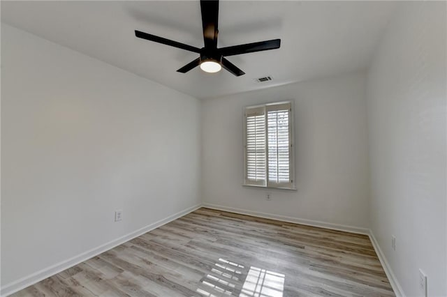 empty room with ceiling fan and light wood-type flooring