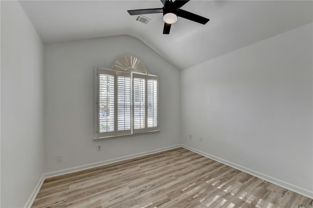 empty room featuring vaulted ceiling, ceiling fan, and light hardwood / wood-style flooring