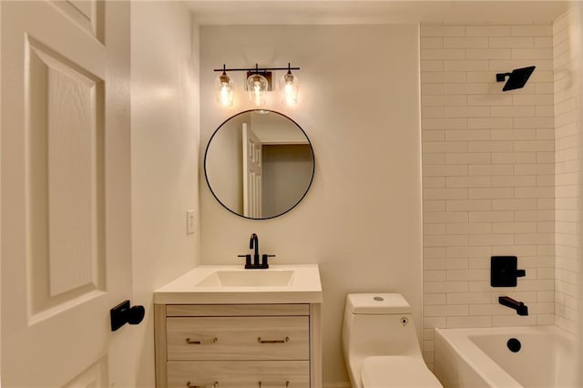 full bathroom with vanity, tiled shower / bath combo, and toilet