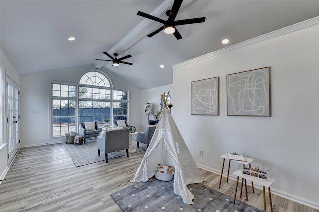 rec room with lofted ceiling with beams, ceiling fan, and light wood-type flooring