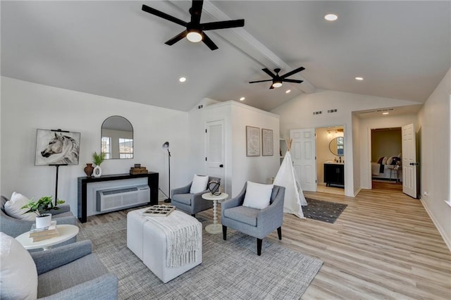 living room featuring vaulted ceiling with beams, light hardwood / wood-style floors, and ceiling fan