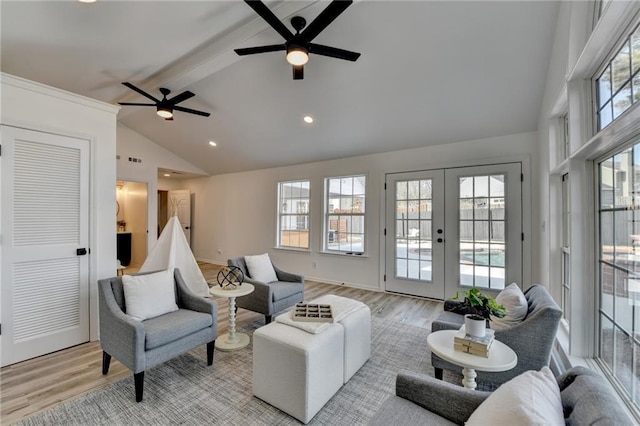 living room featuring ceiling fan, beam ceiling, high vaulted ceiling, french doors, and light wood-type flooring