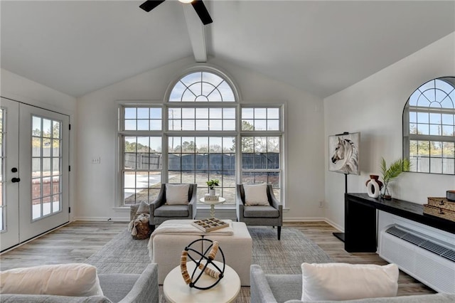 living room with high vaulted ceiling, light hardwood / wood-style flooring, ceiling fan, beam ceiling, and french doors